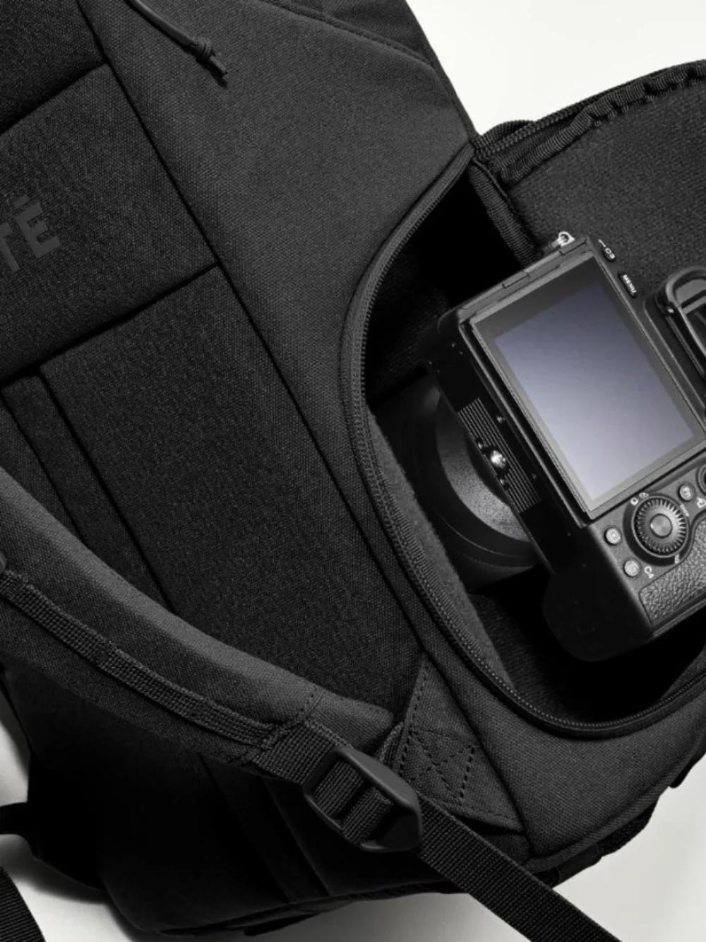 The Jumper Camera Backpack in Black with rain protection